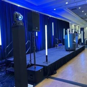 High-quality sound system setup with speakers, mixer, and microphones arranged for a live music or DJ event.