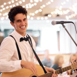 Live musicians performing elegant background music at an outdoor ceremony and cocktail reception.