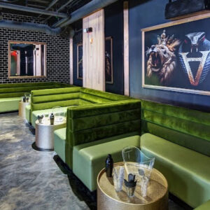 Private art and entertainment lounge featuring modern décor, ambient lighting, and live performance area for an exclusive event experience.