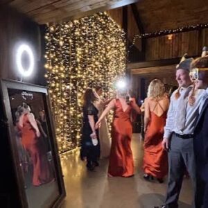 Modern photo and video lounge setup with professional lighting, backdrop, and camera equipment for guests to capture memories.